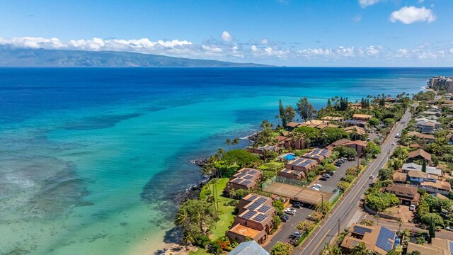 drone / aerial view featuring a water and mountain view