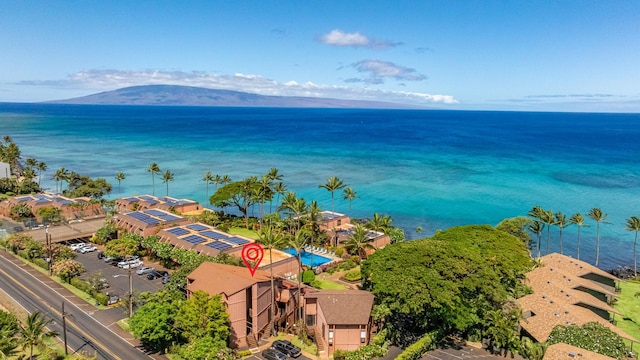 drone / aerial view featuring a water and mountain view