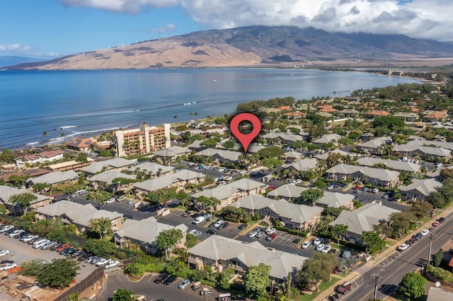 drone / aerial view with a water and mountain view