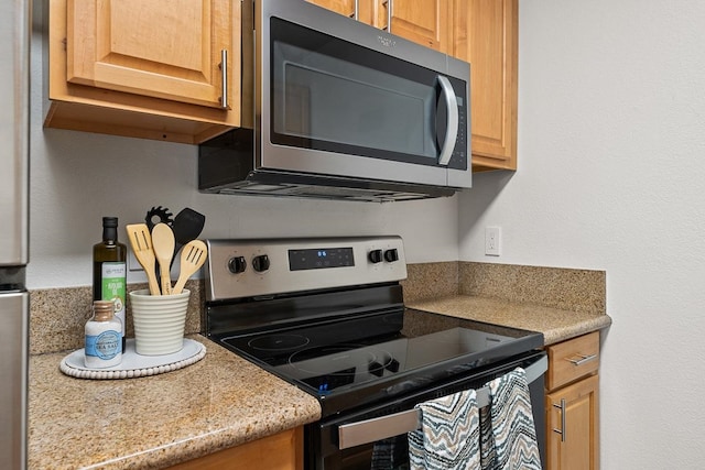 kitchen featuring light stone countertops and stainless steel appliances