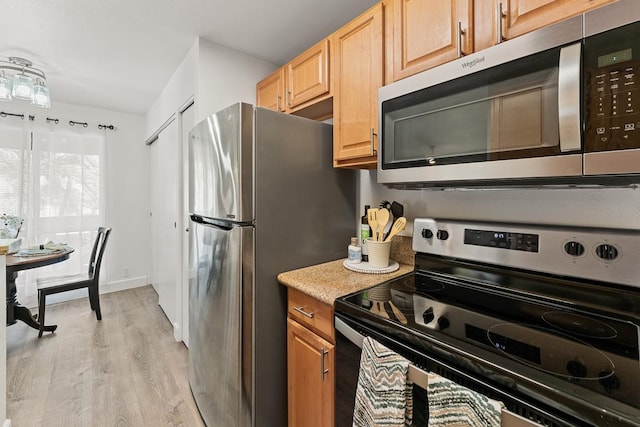 kitchen featuring appliances with stainless steel finishes and light wood-type flooring