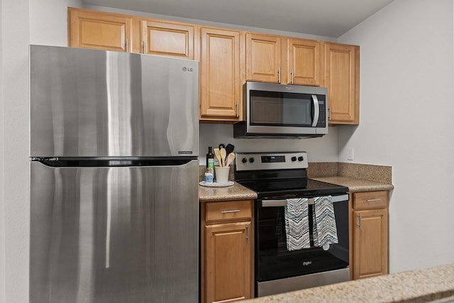 kitchen featuring light brown cabinets and stainless steel appliances