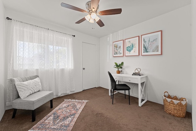 carpeted office space with ceiling fan