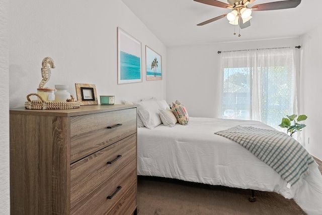 bedroom with dark carpet and ceiling fan