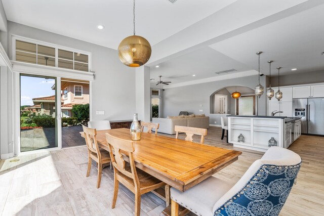 dining space with ceiling fan and light hardwood / wood-style floors