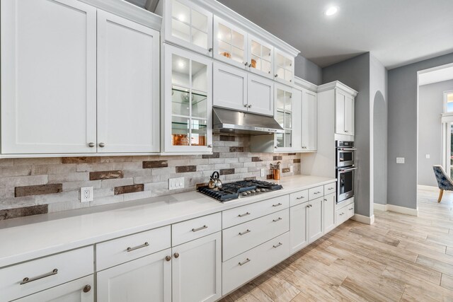 kitchen with white cabinets and decorative backsplash