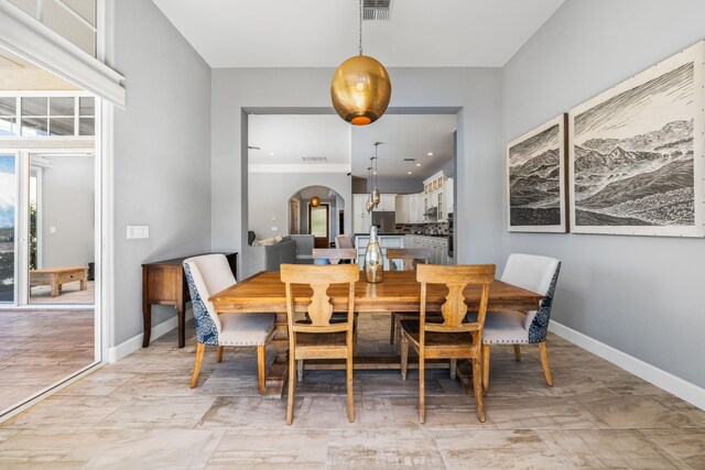 dining area with plenty of natural light and light tile patterned floors