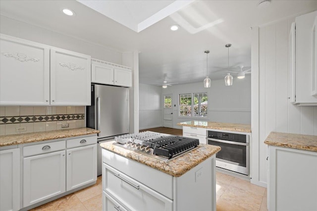 3217 Luahine Pl, Haiku, HI 96708 - kitchen featuring appliances with stainless steel finishes, a ceiling fan, white cabinetry, tasteful backsplash, and recessed lighting
