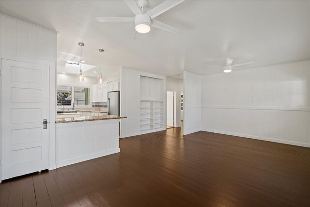3217 Luahine Pl, Haiku, HI 96708 - unfurnished living room with a ceiling fan and dark wood-style flooring