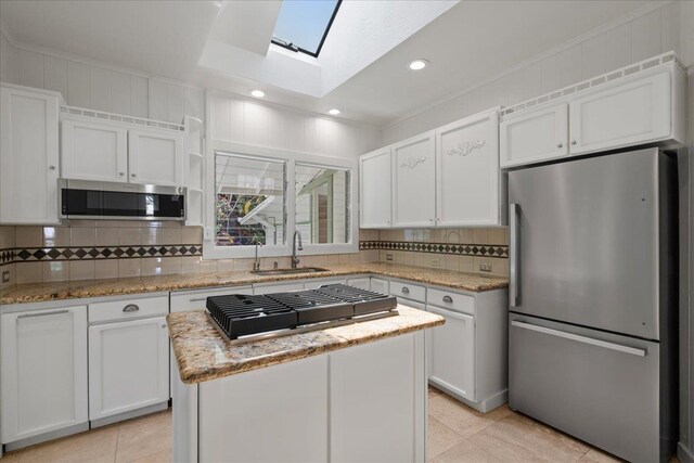 3217 Luahine Pl, Haiku, HI 96708 - kitchen with appliances with stainless steel finishes, a sink, a skylight, light tile patterned floors, and recessed lighting