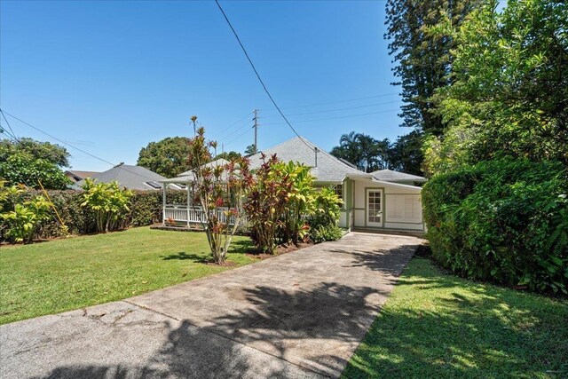 3217 Luahine Pl, Haiku, HI 96708 - obstructed view of property with concrete driveway, a front yard, and stucco siding