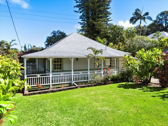 3217 Luahine Pl, Haiku, HI 96708 - farmhouse featuring a porch, roof with shingles, and a front yard