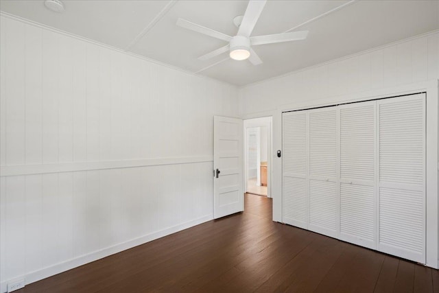 3217 Luahine Pl, Haiku, HI 96708 - unfurnished bedroom featuring dark wood-type flooring, a closet, a ceiling fan, baseboards, and ornamental molding