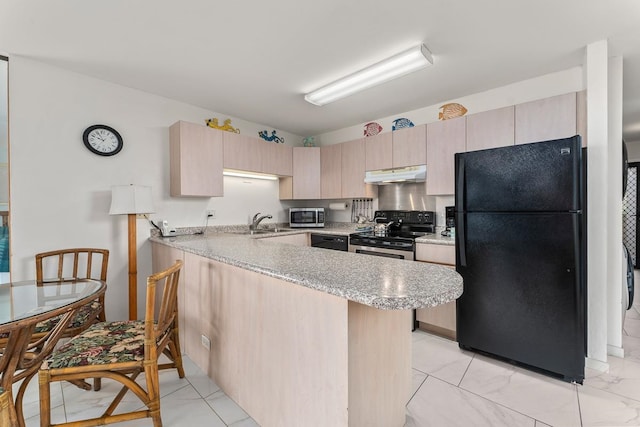 kitchen with light brown cabinets, light tile floors, light stone countertops, black appliances, and sink