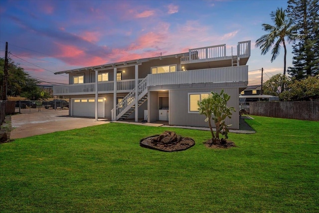402 Auhana Rd, Kihei, HI 96753 - rear view of property featuring stairs, concrete driveway, a garage, and an outdoor fire pit