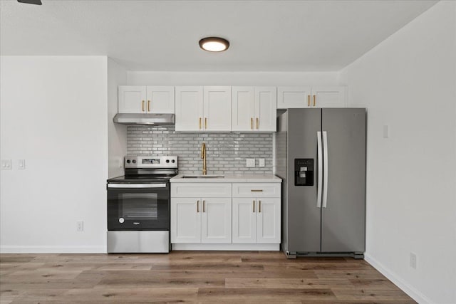 402 Auhana Rd, Kihei, HI 96753 - kitchen featuring appliances with stainless steel finishes, decorative backsplash, white cabinetry, light countertops, and under cabinet range hood