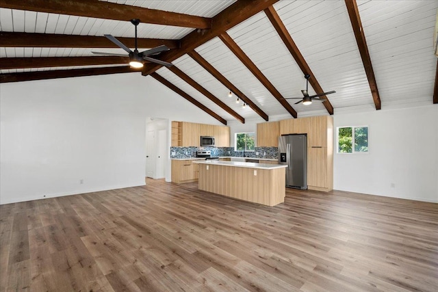402 Auhana Rd, Kihei, HI 96753 - kitchen with stainless steel appliances, a ceiling fan, open floor plan, a kitchen island, and high vaulted ceiling