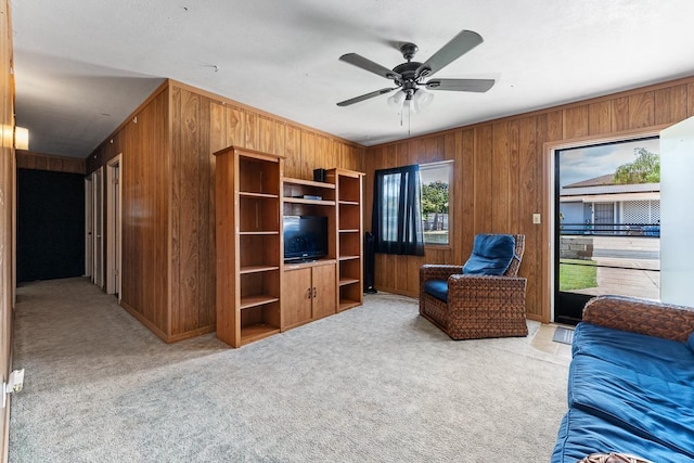 119 Kupalaiki Loop, Kihei, HI 96753 - living area with wood walls, light carpet, and ceiling fan