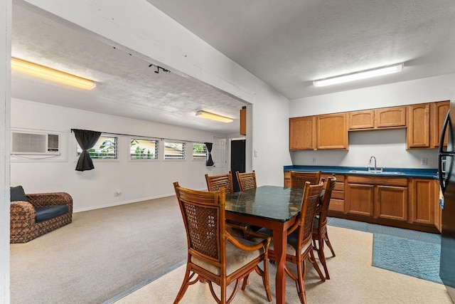 119 Kupalaiki Loop, Kihei, HI 96753 - dining area with a textured ceiling, an AC wall unit, light colored carpet, and baseboards