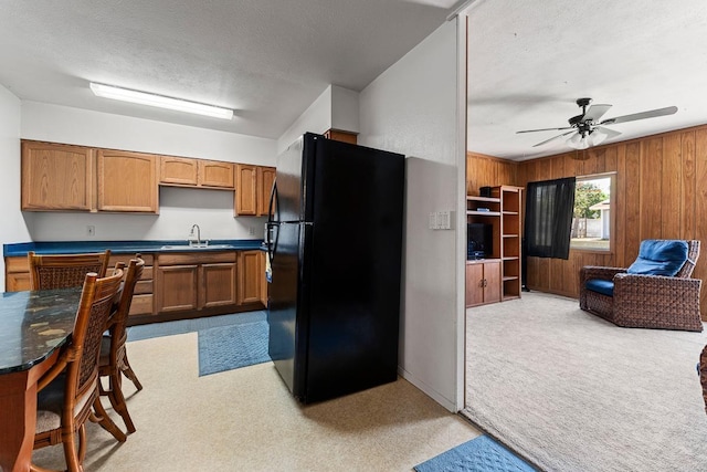 119 Kupalaiki Loop, Kihei, HI 96753 - kitchen featuring freestanding refrigerator, dark countertops, wooden walls, a sink, and ceiling fan