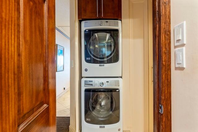 2075 S Kihei Rd Unit 214, Kihei, HI 96753 - laundry area with stacked washer / drying machine, tile patterned floors, and cabinet space