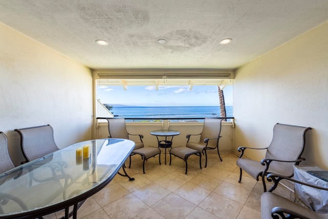 2075 S Kihei Rd Unit 214, Kihei, HI 96753 - dining area featuring a water view, a textured ceiling, recessed lighting, and light tile patterned flooring