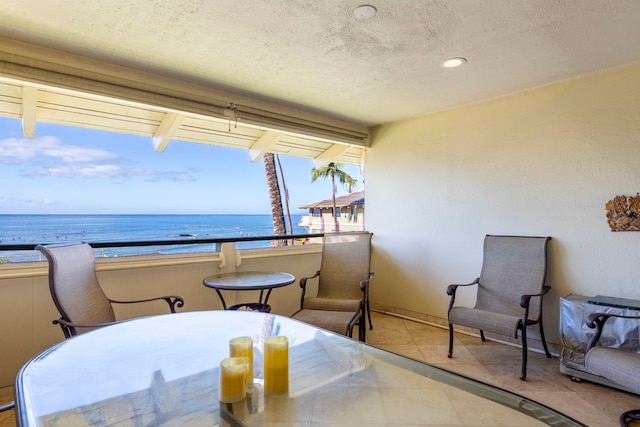 2075 S Kihei Rd Unit 214, Kihei, HI 96753 - dining area featuring a water view, a textured ceiling, tile patterned floors, and recessed lighting
