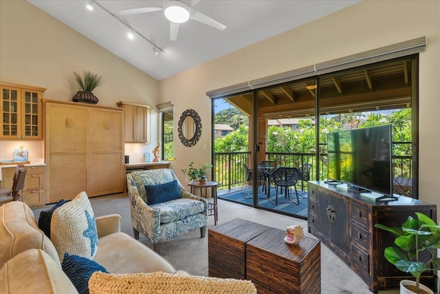 carpeted living room with lofted ceiling and ceiling fan