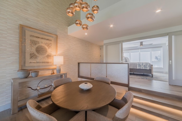 3200 Wailea Alanui Dr Unit 1606, Kihei, HI 96753 - dining room featuring wood finished floors, wallpapered walls, a ceiling fan, and a chandelier