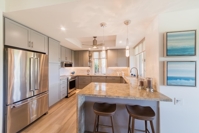 3200 Wailea Alanui Dr Unit 1606, Kihei, HI 96753 - kitchen featuring stainless steel appliances, a raised ceiling, a peninsula, open shelves, and tasteful backsplash