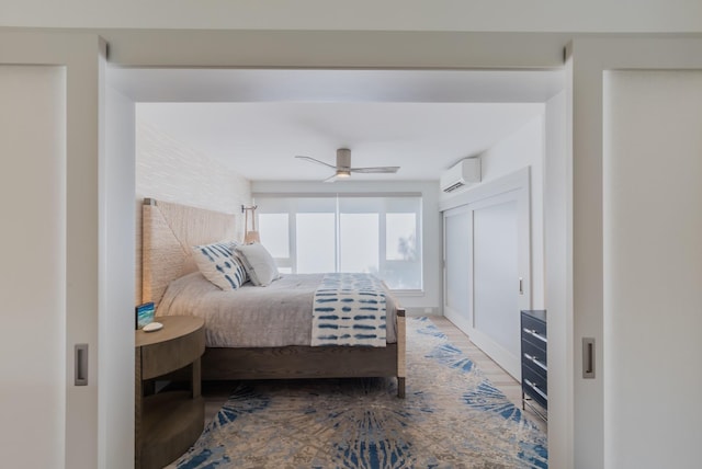 3200 Wailea Alanui Dr Unit 1606, Kihei, HI 96753 - bedroom with a wall mounted air conditioner, wood finished floors, and a ceiling fan