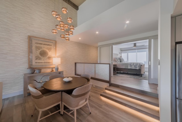 3200 Wailea Alanui Dr Unit 1606, Kihei, HI 96753 - dining area with wood finished floors, ceiling fan, a chandelier, and wallpapered walls