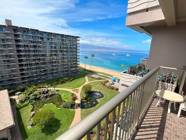 balcony featuring a water view and a beach view