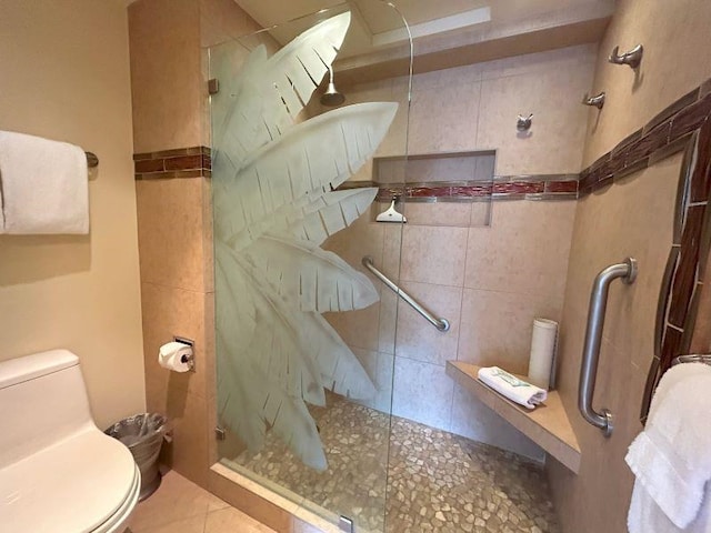 bathroom with tile patterned flooring, walk in shower, and toilet