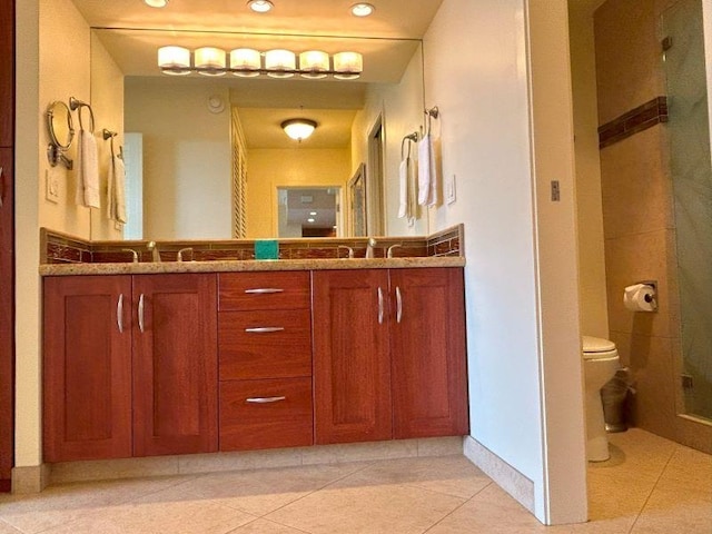 bathroom featuring vanity, tile patterned flooring, toilet, and an enclosed shower