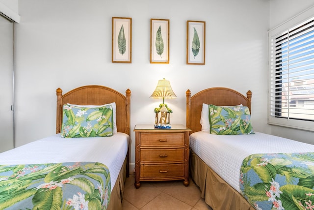 bedroom featuring a closet and light tile patterned flooring