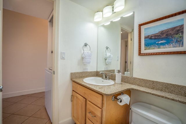 bathroom featuring tile patterned floors, vanity, and toilet