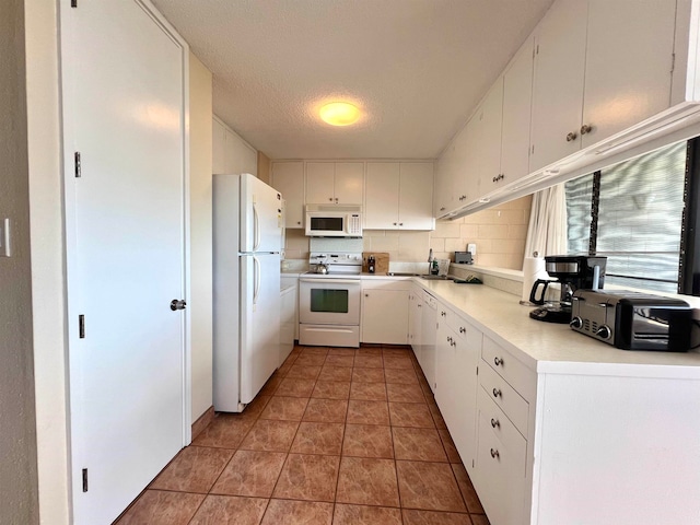 kitchen with white cabinetry, tile flooring, white appliances, and backsplash