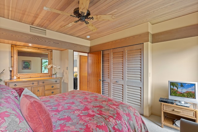 carpeted bedroom featuring a closet, ceiling fan, and wood ceiling