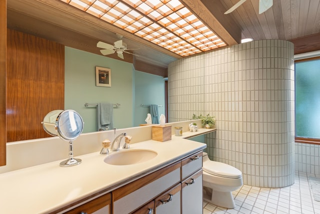 bathroom with vanity with extensive cabinet space, tile flooring, wood ceiling, toilet, and ceiling fan