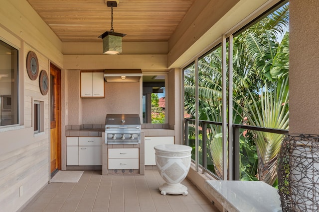 exterior space with exterior kitchen, a balcony, and grilling area