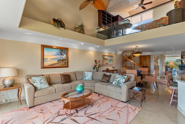 tiled living room with a towering ceiling and ceiling fan