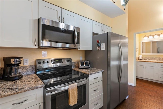 kitchen featuring white cabinetry, dark wood-type flooring, and stainless steel appliances