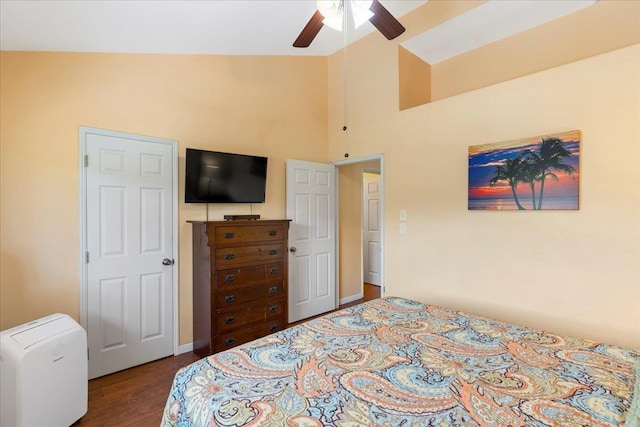 bedroom featuring ceiling fan, wood-type flooring, and high vaulted ceiling