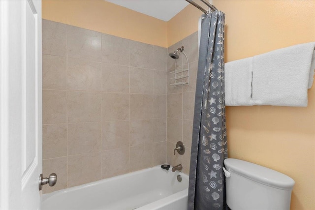 bathroom with shower / bath combo with shower curtain and toilet