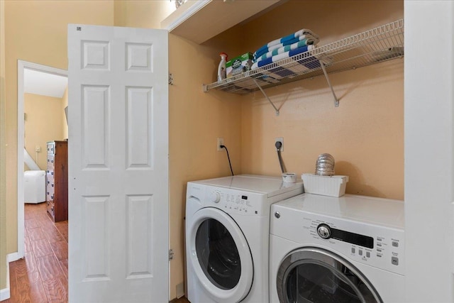 washroom with washer and dryer and hardwood / wood-style floors