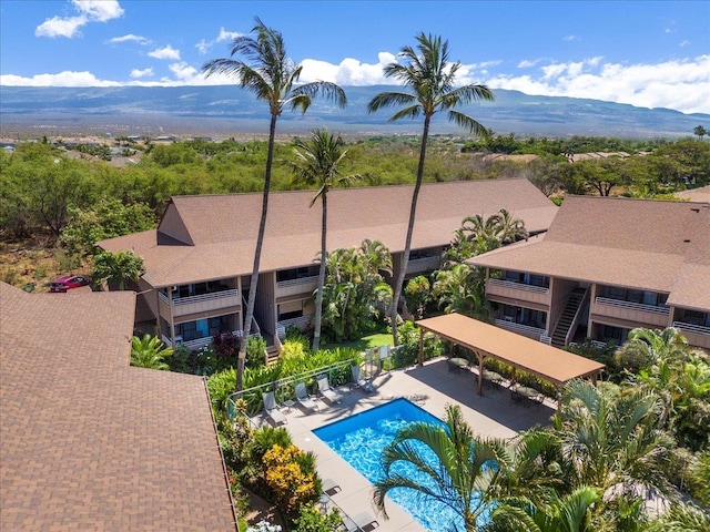 view of pool with a patio and a mountain view