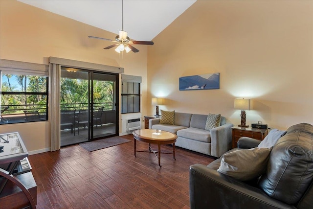 living room featuring dark wood-type flooring, ceiling fan, and high vaulted ceiling