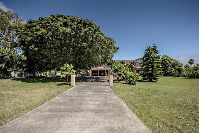 view of front of property with a front lawn and a garage