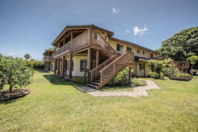 back of house featuring a yard and a wooden deck